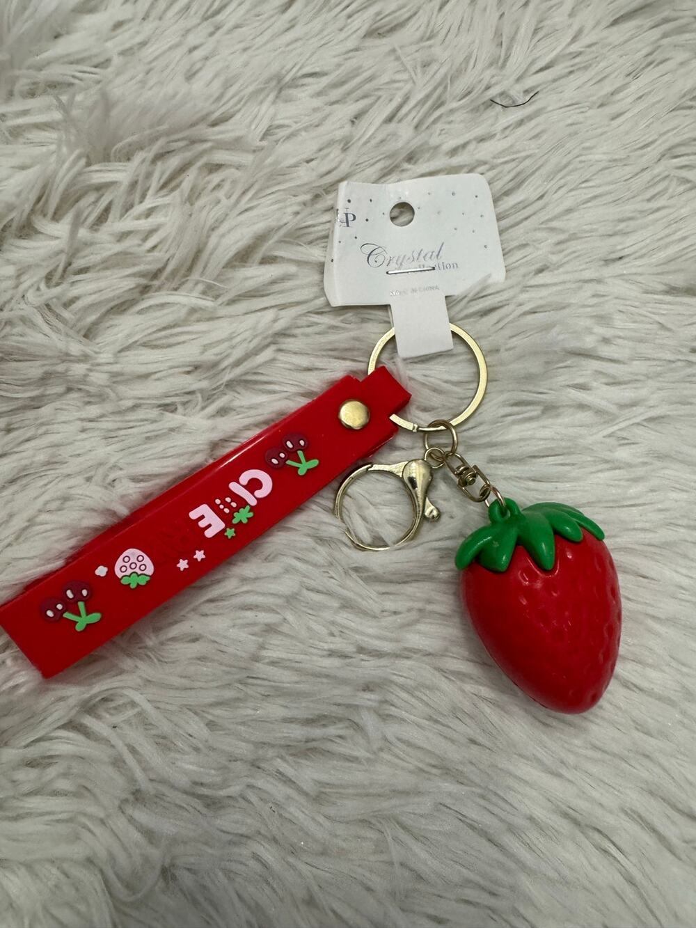 Red strawberry rubber keychain with green leafy top gold metal